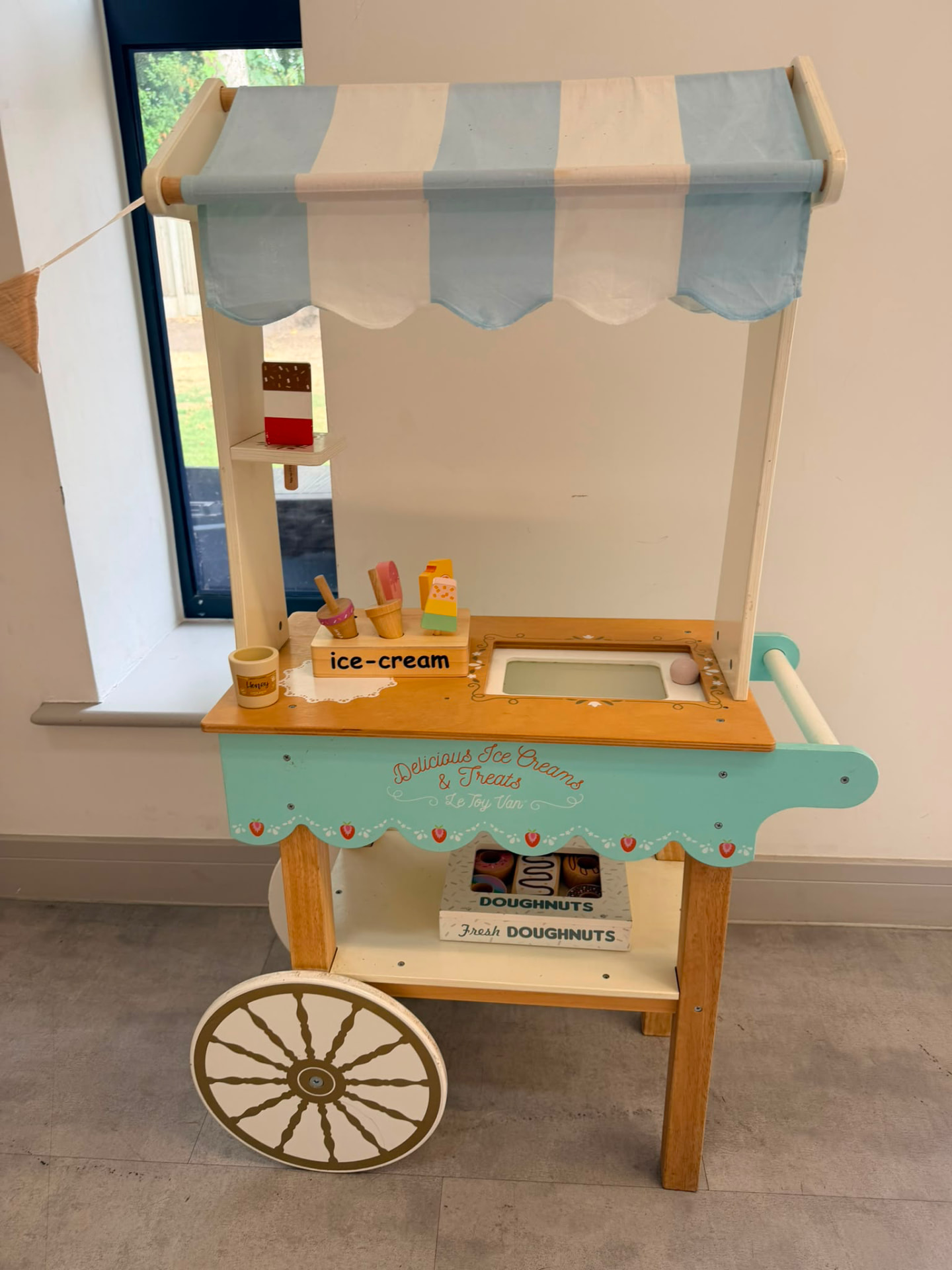 Wooden ice cream cart play set at a session